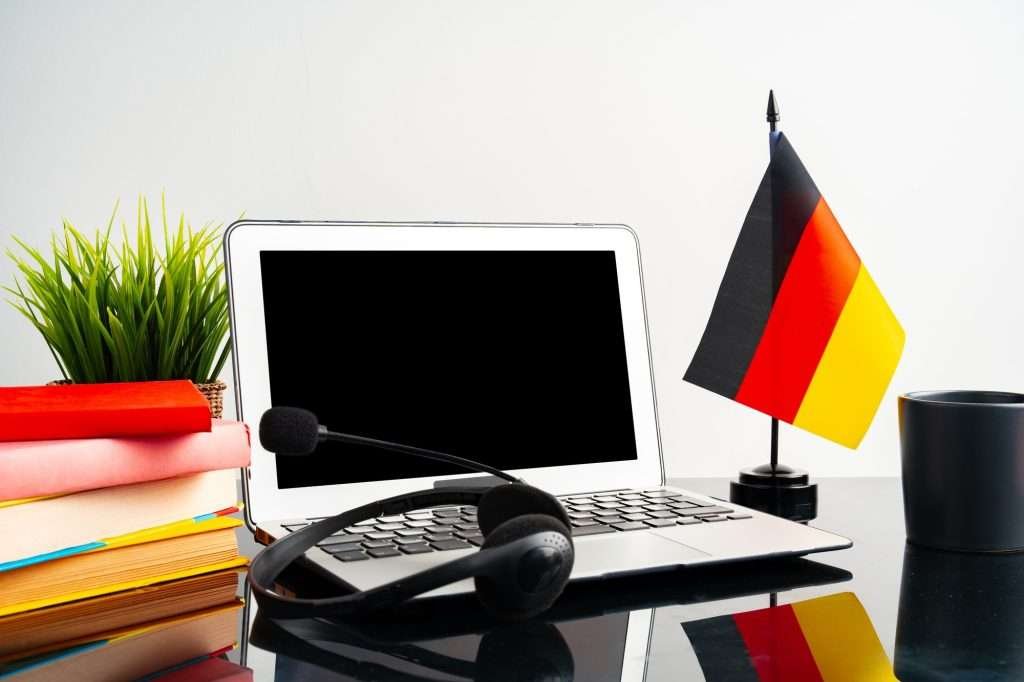 Laptop with German flag on working table, educational concept