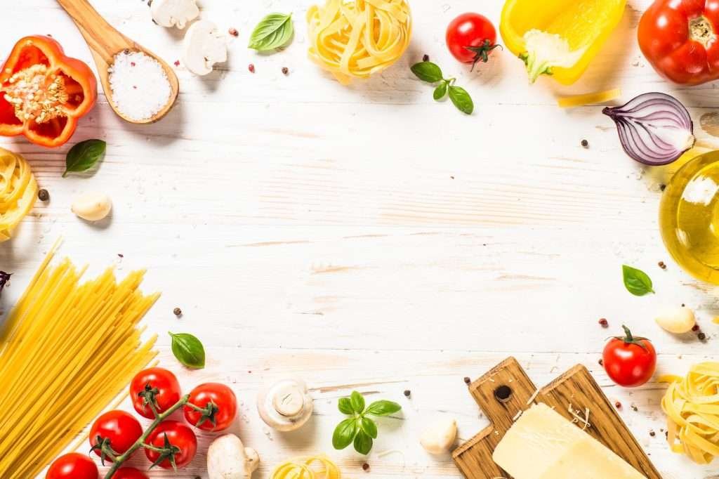 Italian food background at white bkitchen table