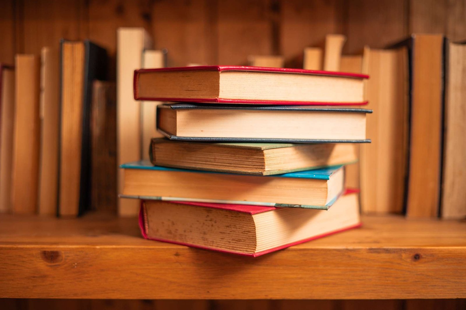 pile of text books in bookcase with blur background world book day