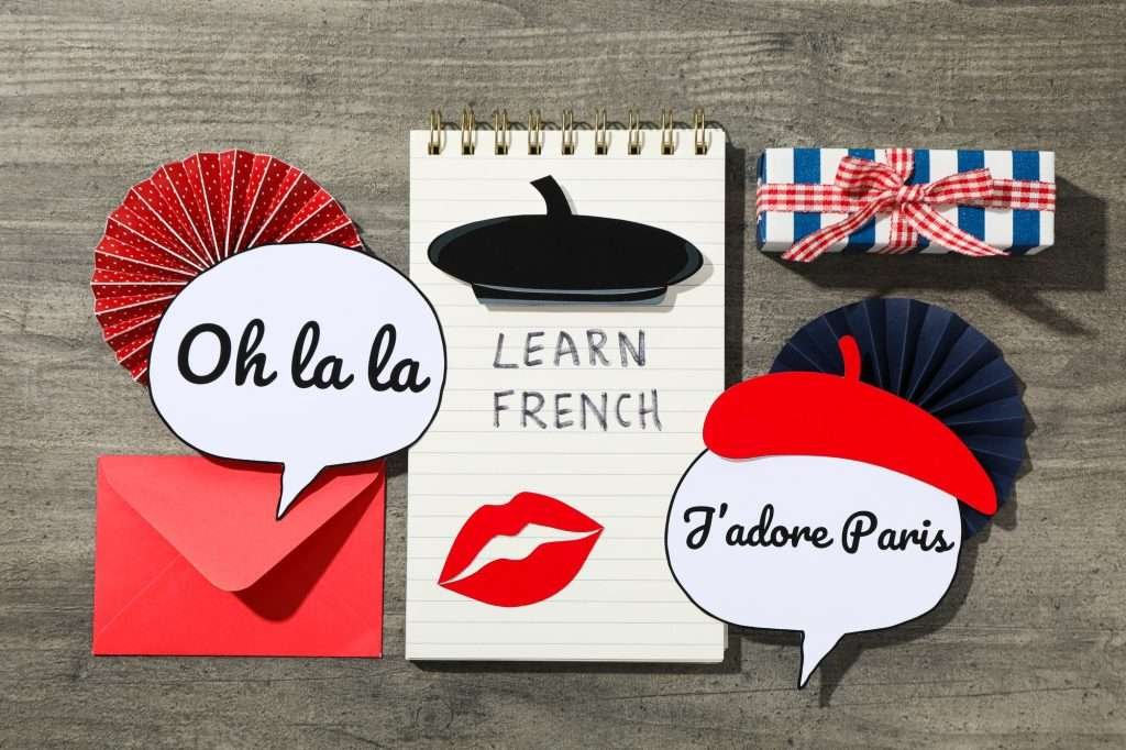 The concept of learning the French language, on a dark background.